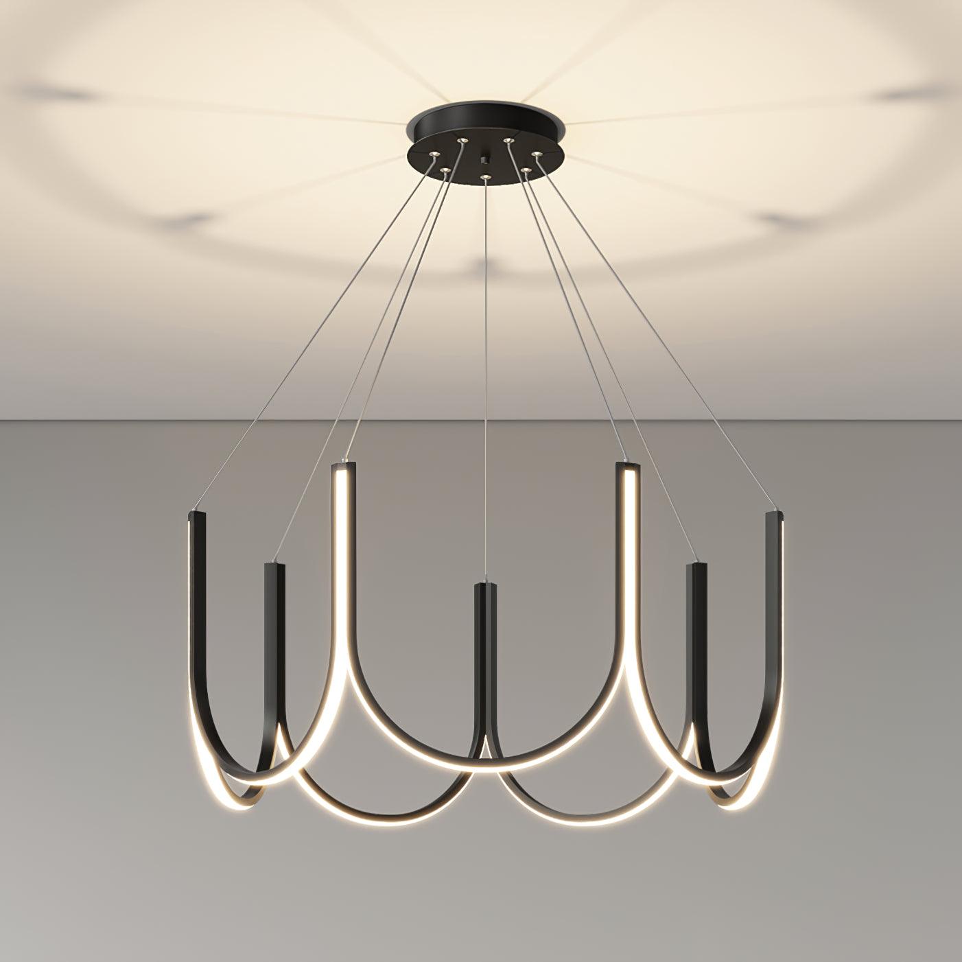 Clérachic looped arm pendant lit close under the ceiling, soft pools of light above.