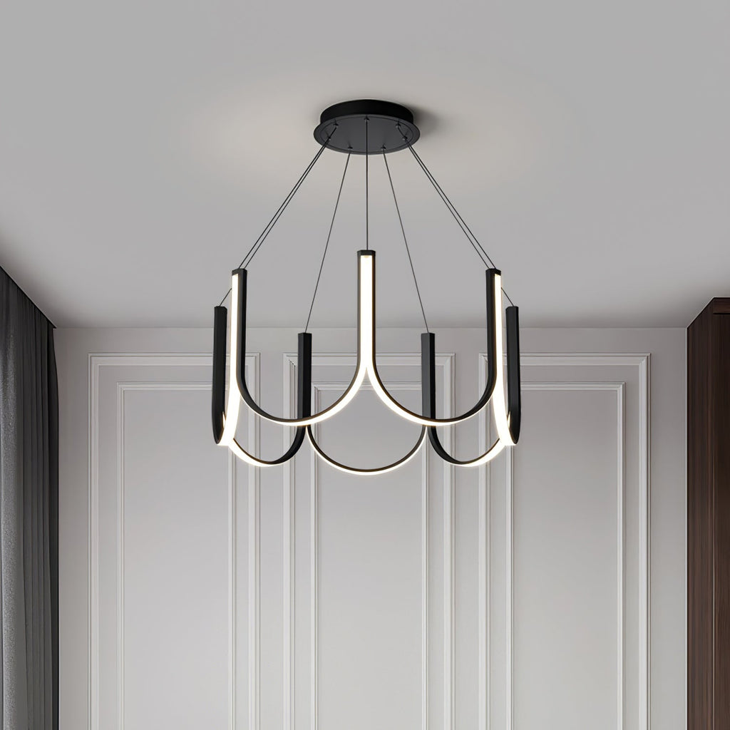 Clérachic looped arm pendant lit in the corner of a panelled white room.