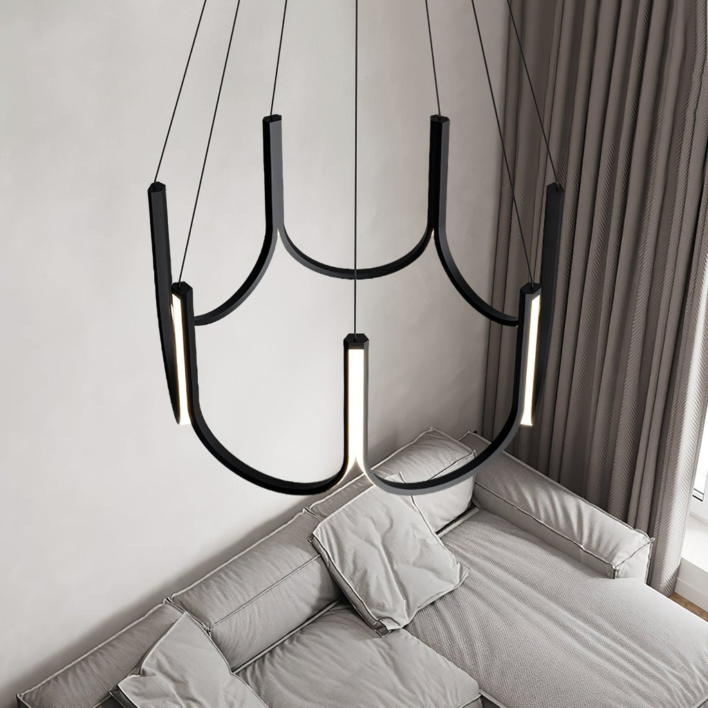 The Clérachic looped arm pendant above a grey sofa and heavy floor-length curtains.