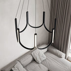 The Clérachic looped arm pendant above a grey sofa and heavy floor-length curtains.