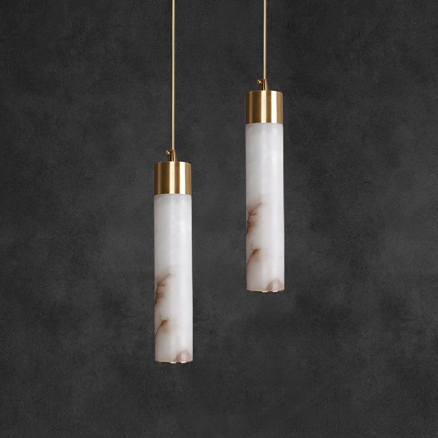 Clérachic shows the cool white and grey marbling of the unlit stone against a charcoal plaster wall.