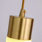 The Clérachic fitting up close: brushed brass cap, knurled cord grip and set screw above the lit alabaster shade.