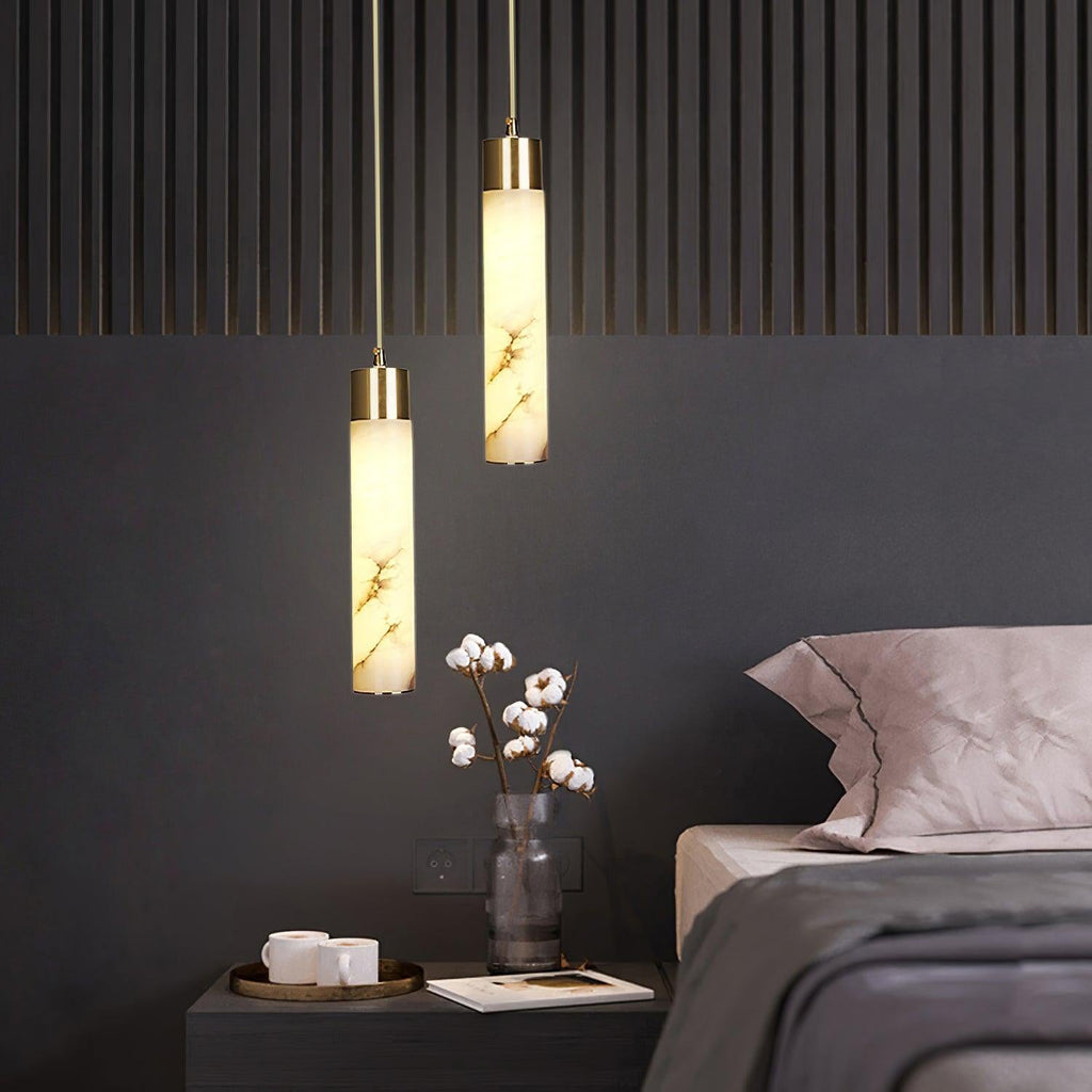 The Clérachic pair lights a fluted timber wall, glowing above cotton stems in a smoked glass vase.