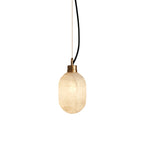 Clérachic Eclipse pendant lit against white, its alabaster shade glowing warm beneath a slim brushed brass collar.