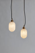 The Clérachic Eclipse pair lit at different drop heights, the veining in each alabaster shade reading clearly.