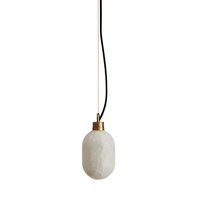 The Clérachic Eclipse pendant on a long black flex, shade unlit so the stone reads chalk white against white.