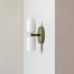 Side view of the Clérachic opal wall sconce in green, showing how little the two shades project from the wall.