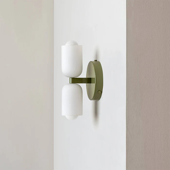 Side view of the Clérachic opal wall sconce in green, showing how little the two shades project from the wall.