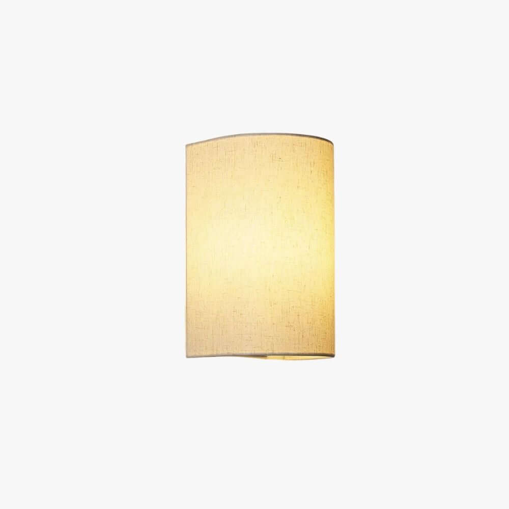 Half-round linen-look fabric wall light, lit warm, with a soft glow through the shade, on a plain white backdrop, from Clérachic.