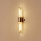 Clérachic Up-Down Wall Sconce switched on, the alabaster glowing honey-amber and washing light up and down a plaster wall.