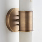 Close-up of the Clérachic Up-Down Wall Sconce's brass collar and backplate, showing the three threaded mounting studs.