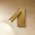 Clérachic wall reading light in bright gold, a knurled cylinder spot with a push switch on a slim rectangular backplate.
