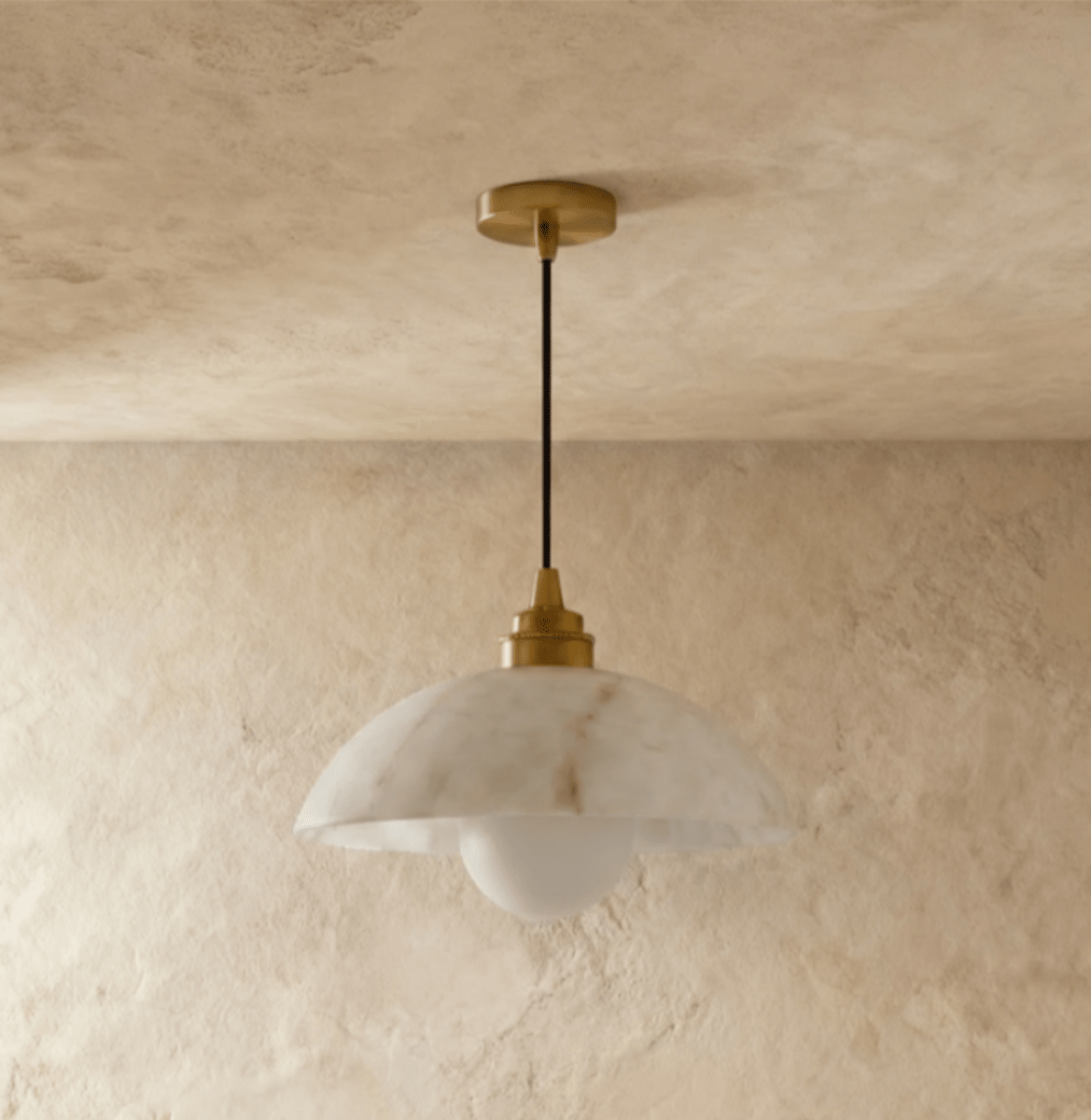 Clérachic veined alabaster dome pendant hung from a gold canopy and black cord, with a frosted globe bulb below.