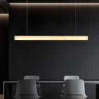 The Clérachic Velmore bar pendant over a dark island with two low chairs pulled up to it.