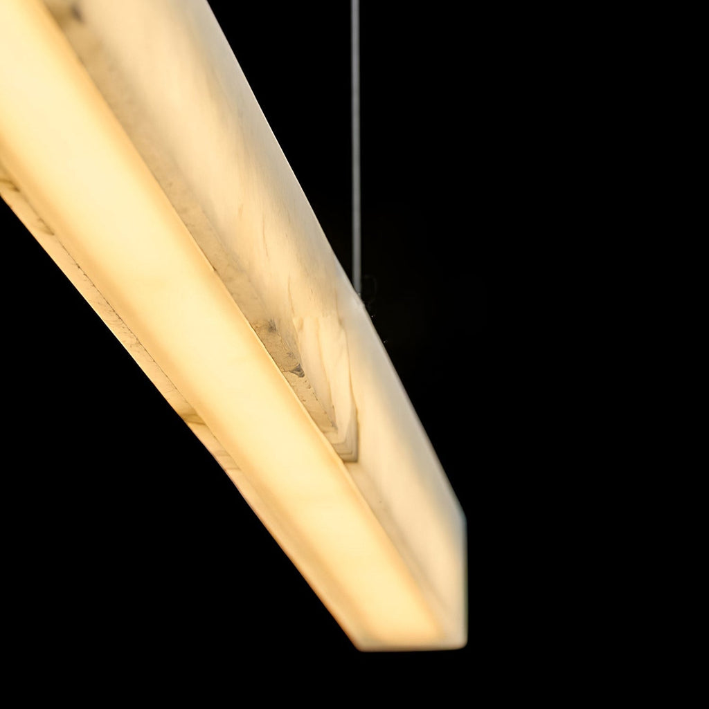 Close angled view of the Clérachic Velmore bar, warm light through the veined alabaster.