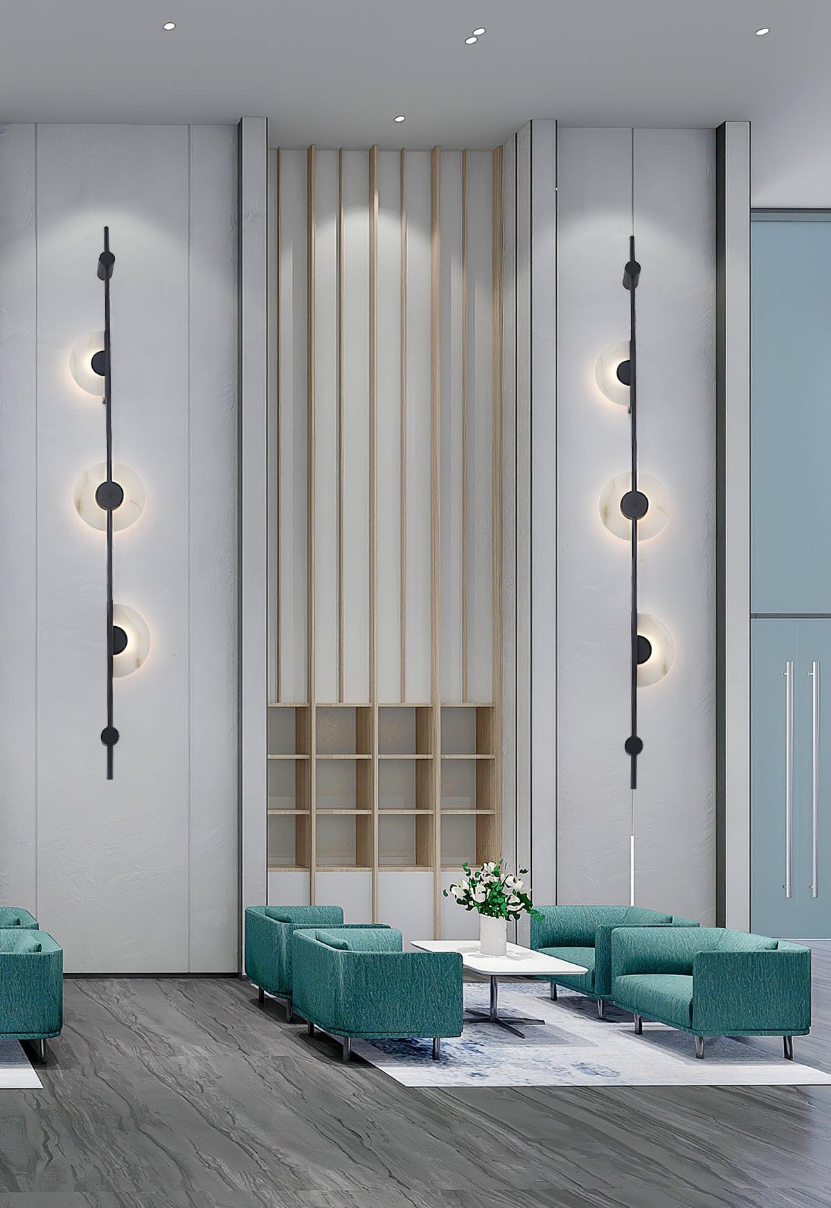A pair of black three-disc Clérachic sconces on a tall pale wall flanking slatted wood panelling, above teal armchairs in a lobby.