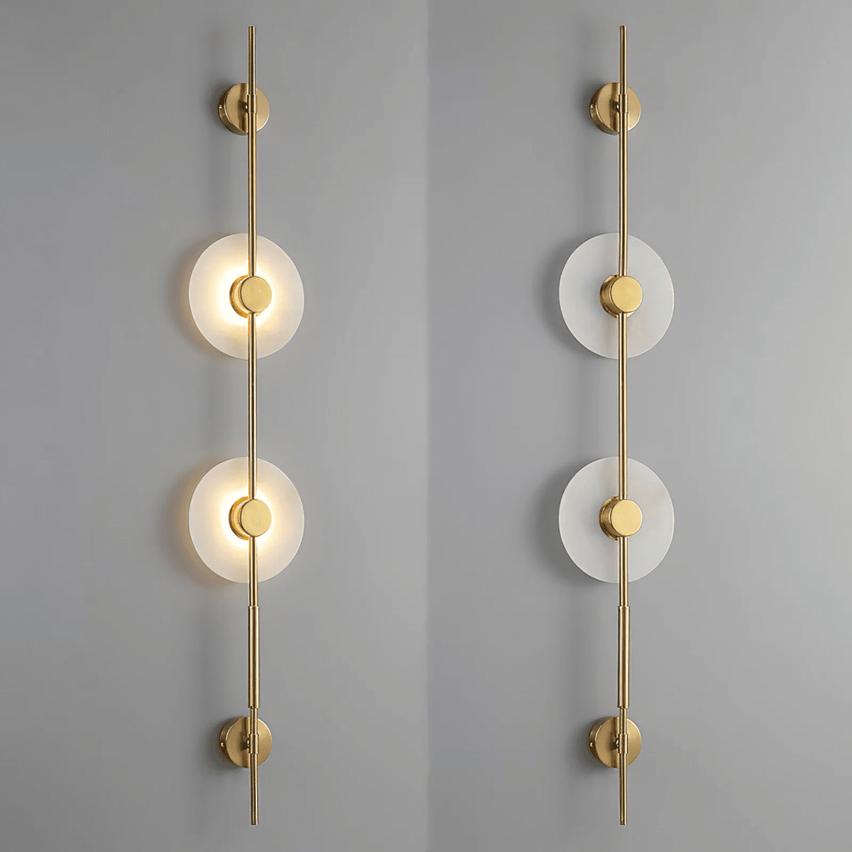 Two gold Clérachic sconces on a grey wall, a two-disc model lit on the left and the same unlit on the right.