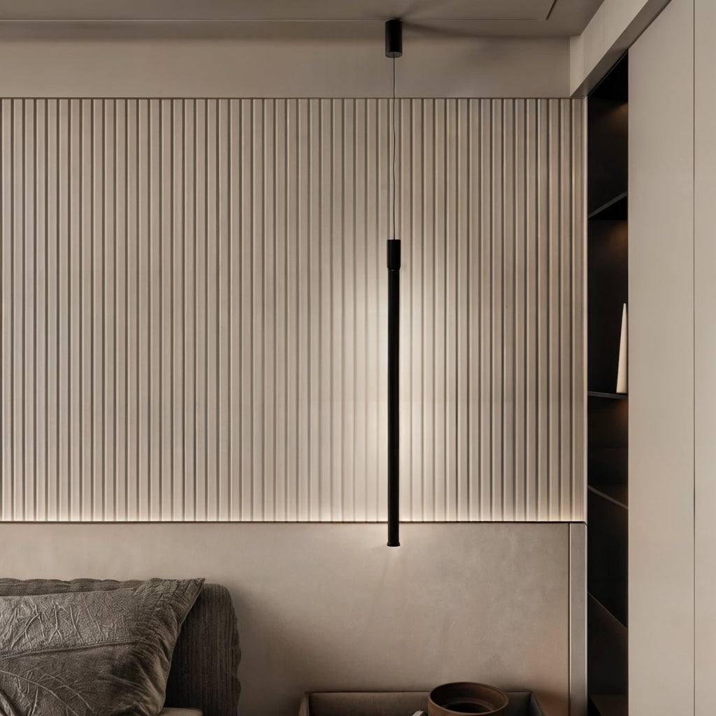 A Clérachic black rod pendant lights a fluted wood headboard panel beside an open bedroom storage nook.