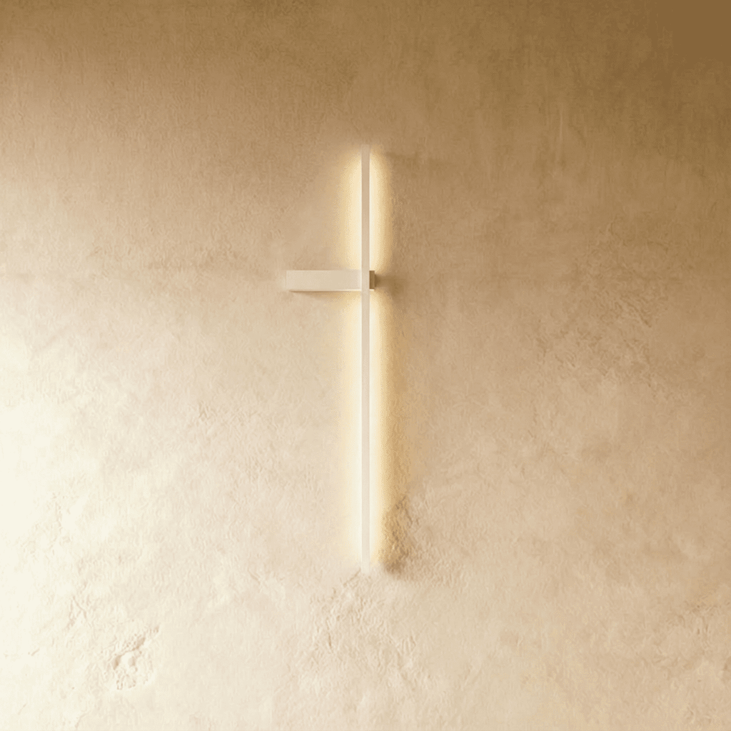 Clérachic slim white LED light bar glowing on a limewash wall, a thin vertical line with a small horizontal bracket.