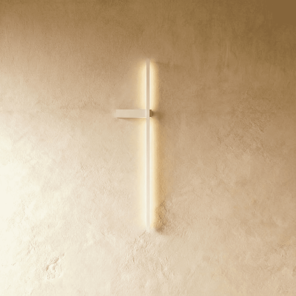 Clérachic slim white LED light bar glowing on a limewash wall, a thin vertical line with a small horizontal bracket.