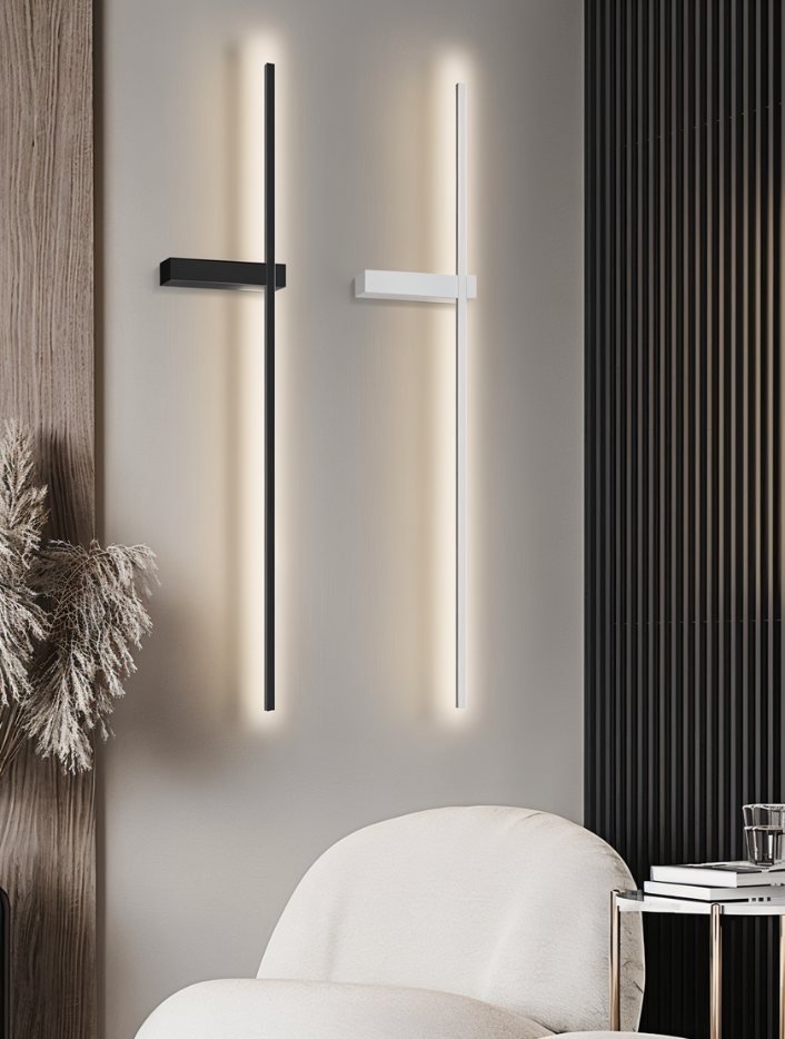 Clérachic black and white LED light bars side by side on a grey wall above a cream armchair and a marble side table.