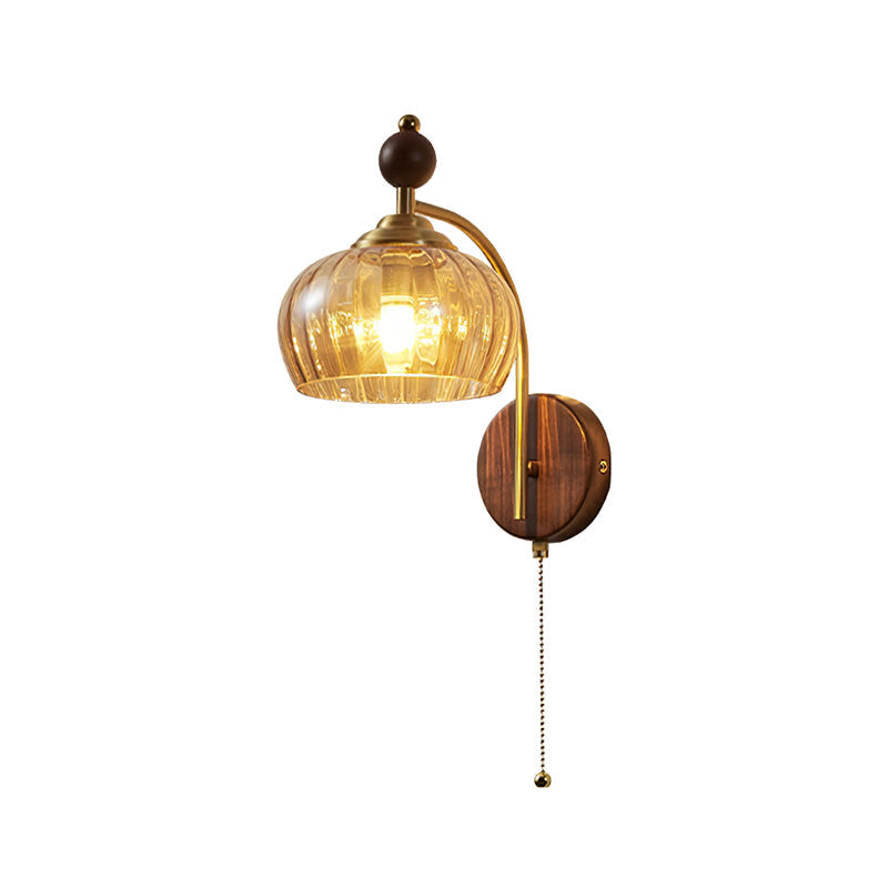 Clérachic wall light with a rounded amber glass shade and a long arm, lit on a white background.