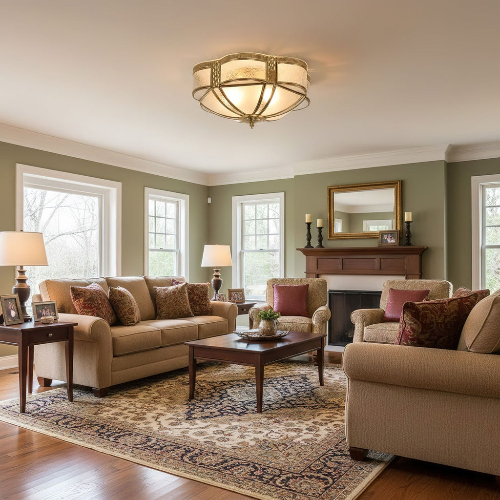 In a green-walled living room with a stone fireplace and a patterned rug, a Clérachic brass ceiling light sits at the centre of the ceiling.