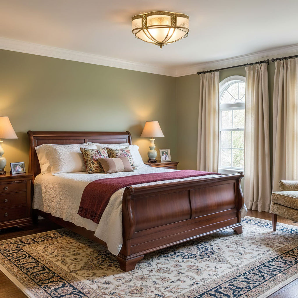 This Clérachic brass ceiling light sits flush above a mahogany sleigh bed in a sage-green bedroom with a patterned rug.