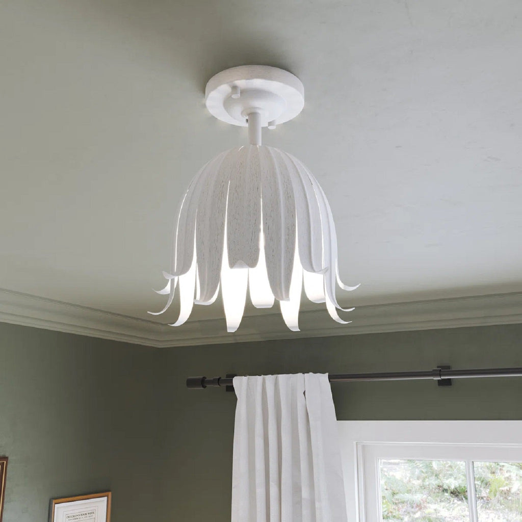 Looking up at this Clérachic ceiling light in vintage white, its petals lit from within, beside a sage wall and a white curtain.