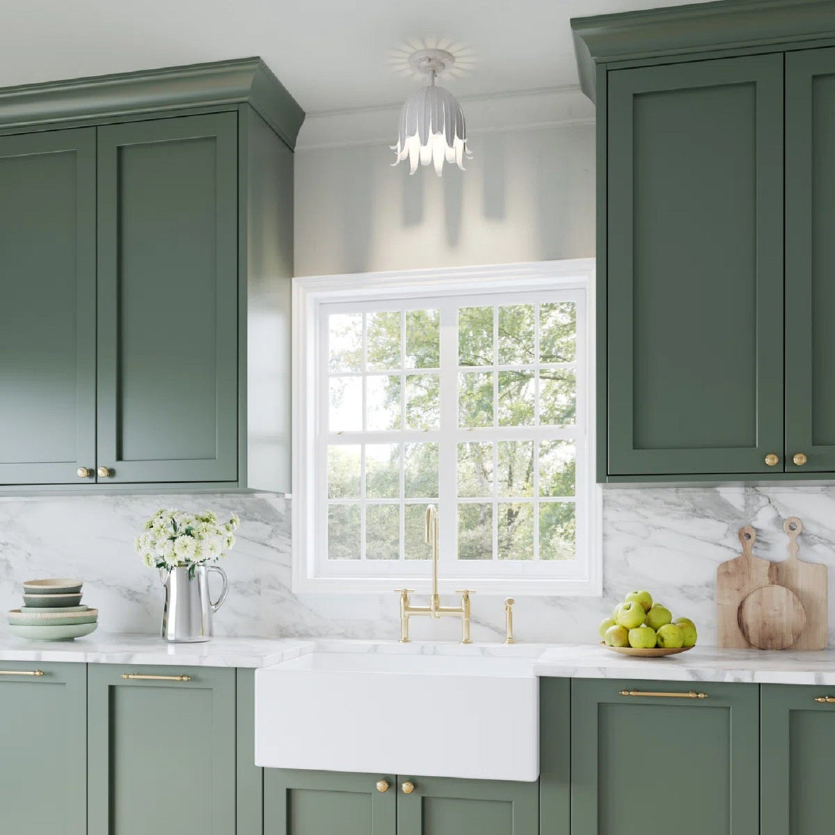Vintage white Clérachic ceiling light above a green-cabinet kitchen, with a farmhouse sink and a marble splashback below.