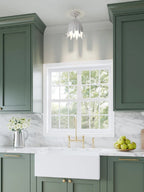 Tall crop of a green kitchen with this Clérachic white ceiling light overhead and a window with a brass tap in view.