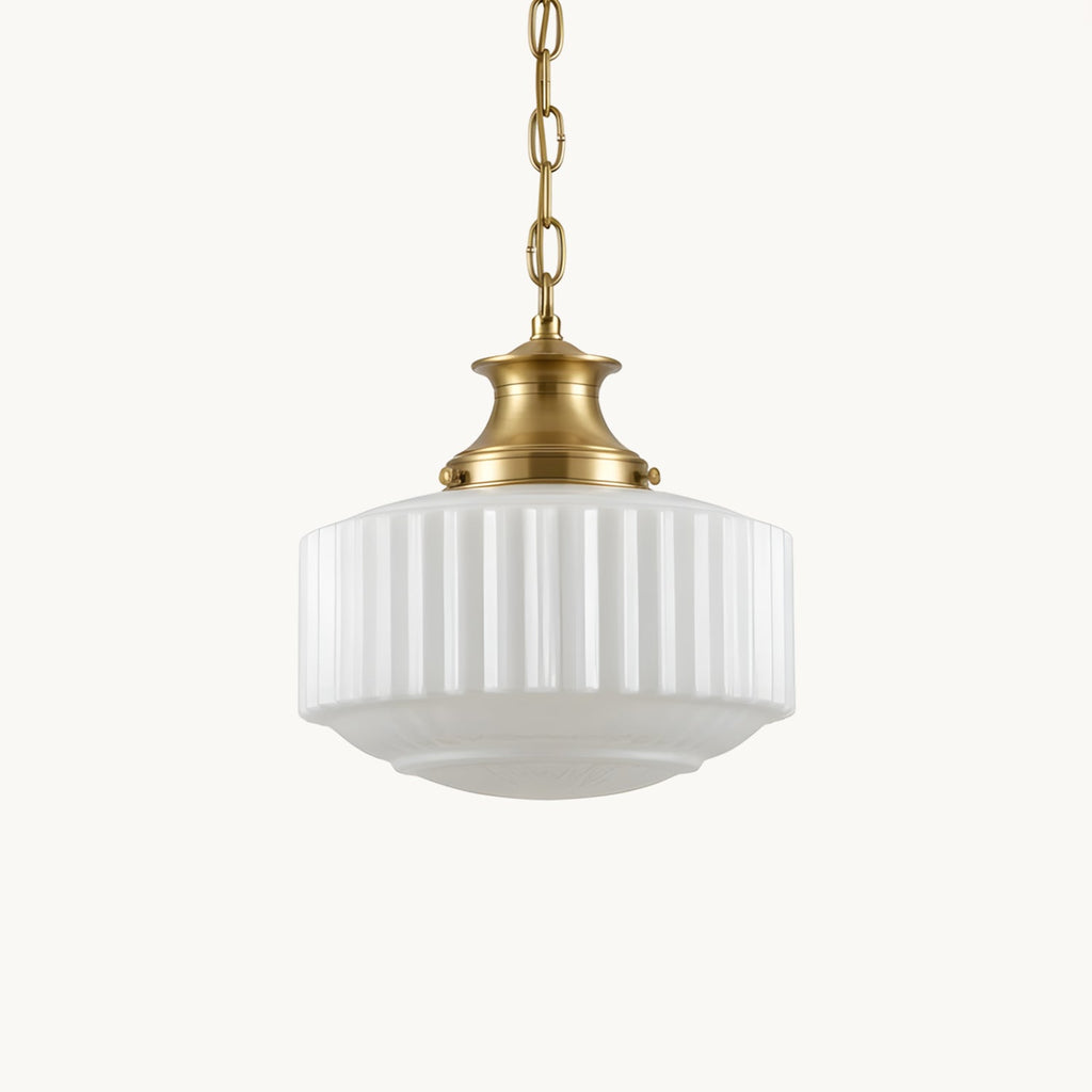 A Clérachic pendant with a ribbed white glass shade and brass cap, hung on a brass chain against a plain white backdrop.