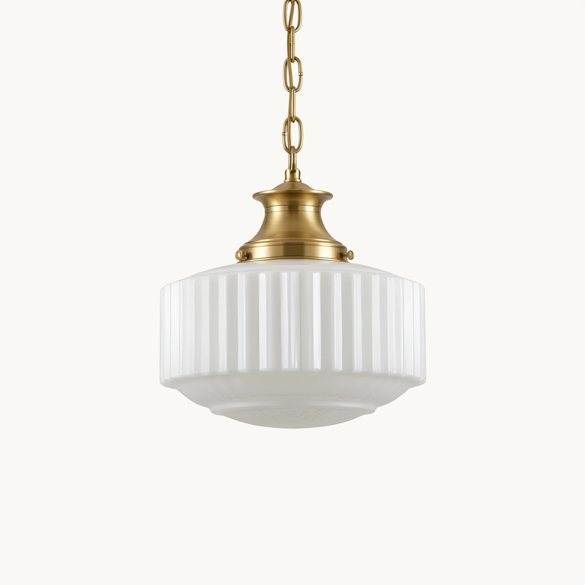 A Clérachic pendant with a ribbed white glass shade and brass cap, hung on a brass chain against a plain white backdrop.