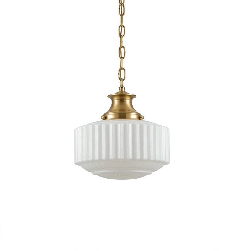 Straight-on view of the Clérachic pendant, showing the fluted white glass shade, brass cap and fine brass chain on white.