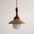 Slightly low angle on this Clérachic pendant, showing the underside of the green shade and the white globe beneath it.