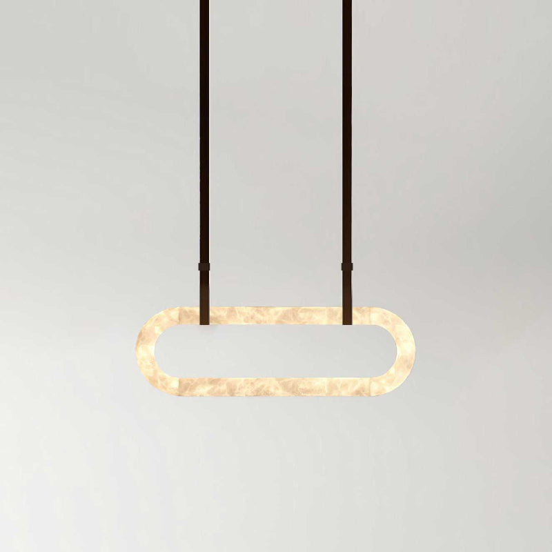 The Clérachic Vista on a long drop of dark faux-leather strapping, the lit stone ring floating clear of the wall.