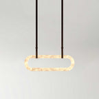 The Clérachic Vista on a long drop of dark faux-leather strapping, the lit stone ring floating clear of the wall.