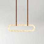 Clérachic Vista seen head-on with tan strap hangers, the alabaster beads glowing evenly across the full oval.