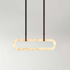 The Clérachic Vista in its wider format, dark strap hangers holding a lit alabaster ring against pale grey.