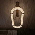 The Clérachic Vista turned vertical against a dark timber ceiling, the alabaster arch glowing above the room.