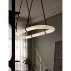The Clérachic Vista hung beside a tall window, its lit alabaster ring catching daylight through sheer curtains.