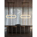 Two Clérachic Vista rings lit over a bar counter and stools, glowing against floor-length sheer curtains.