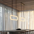 The Clérachic Vista in pairs beneath a timber ceiling, lit rings hovering over a dark dining table.