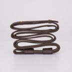 Clérachic Vista strapping in dark brown, looped and clasped with brass fittings on a plain white surface.
