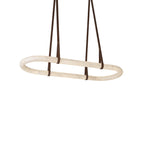The Clérachic Vista at its shortest oval, dark faux-leather hangers meeting the unlit alabaster on white.