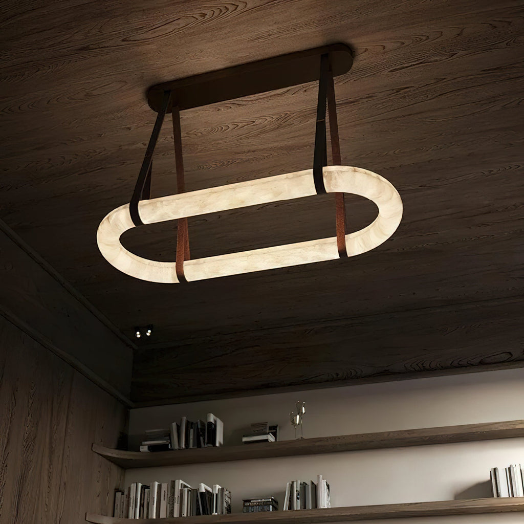 Clérachic Vista seen from beneath, the alabaster ring bright against dark wood with straps set into a bronze plate.