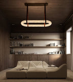 The Clérachic Vista lighting a panelled study, hung above a low modular sofa and full bookshelves.