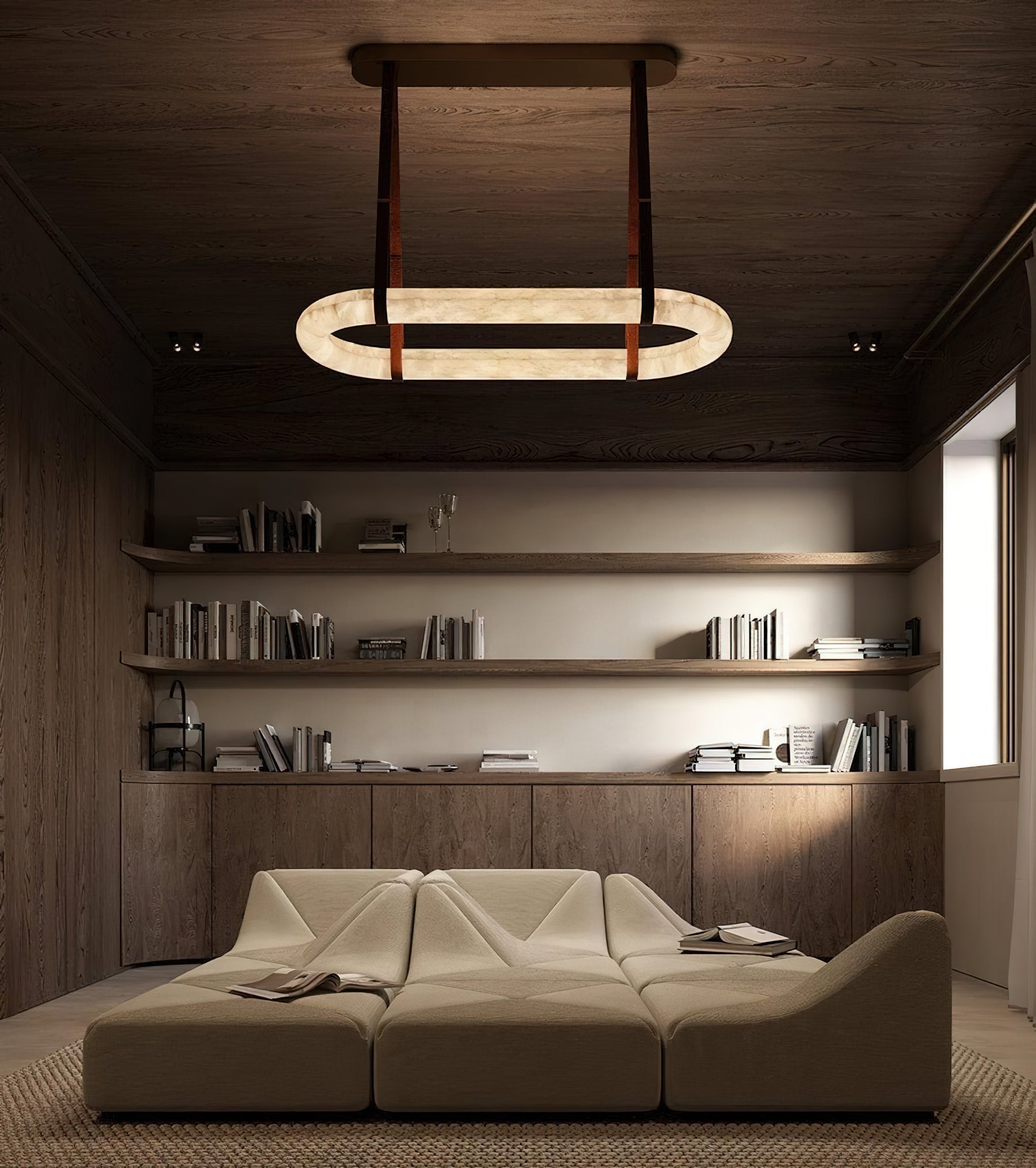 The Clérachic Vista lighting a panelled study, hung above a low modular sofa and full bookshelves.