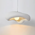 White Clérachic pendant lit above a grey wall, with a pool of warm light spreading below the rough-textured shade.
