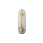 The Clérachic tall alabaster wall lamp unlit on white, showing the pale stone slab and its two brushed brass discs.